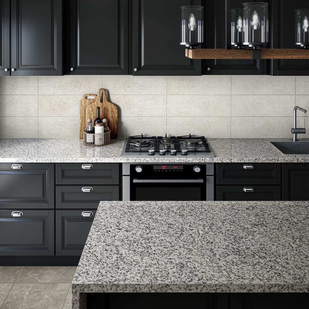 Grey marble kitchen countertop and island, with black cabinets and integrated oven