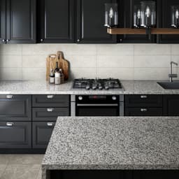 Grey marble kitchen countertop and island, with black cabinets and integrated oven